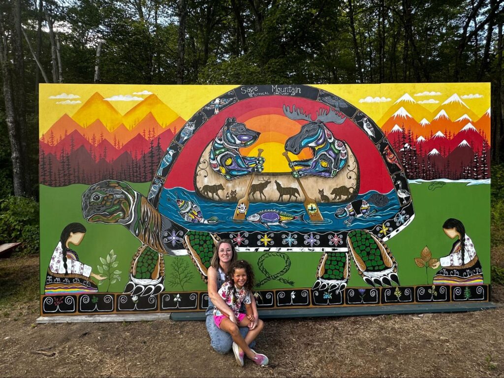 Focal Point Artistry lead artist discussing mural designs and colour palettes with community members and project stakeholders during the planning phase.